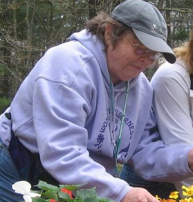 Leslie 'Lefty' Scott organizing flower pots during a Womens Wilderness Weekend event.